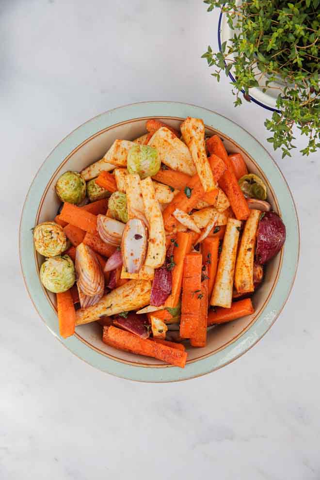 Vegan honey flavouring, caramelised lemon slices and fresh thyme give these roasted root veggies a delicious zesty tang! Top with crunchy pecans and vegan feta cheese and this dish becomes so much more than just a side! #veganhoney #roastveg #rootveg #sides #sidedishes #roastlemon | Recipe on thecookandhim.com