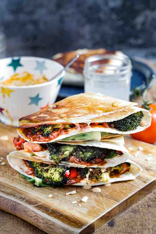 Tonnes of veggies and flavour crammed into folded tortilla wraps. They're crunchy on the outside, warm, cheesy and delicious on the inside! Great for brunch with friends and simple enough for a family weeknight dinner! #vegan #tiktokwraps #foldedwraps #veganrecipes #veganbbq #jackfruitrecipes #plantbased #meatfreemeal | Recipe on thecookandhim.com