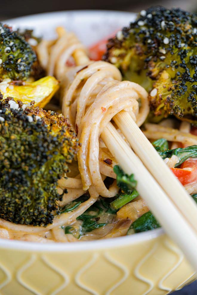 An Asian inspired recipe that's full of flavour and so easy to make. Fresh veggies in a rich, creamy, spicy Thai coconut sauce served with soft noodles for perfect weeknight comfort food! #thiafood #vegan #thaicurry #curry #noodles #redcurry #vegancurry | Recipe on thecookandhim.com