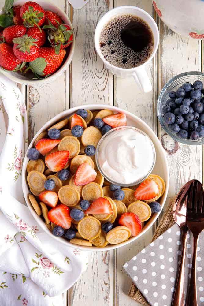 Have fun with your breakfast by making mini pancake cereal! Dinky little pancakes with fresh fruit and whipped cream #pancakes #veganpancakes #pancakecereal #veganbreakfast #veganrecipes #thecookandhim | Recipe on thecookandhim.com