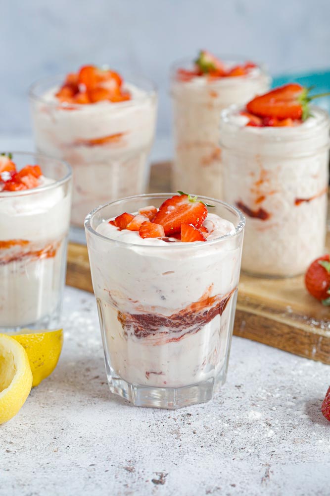 Full of bright, fresh flavour, this fruity fool is a creamy base swirled with the easiest rhubarb and strawberry jam. A deliciously light and fruity summer dessert | Recipe on thecookandhim.com #fruitfool #summerdessert #veganfool #rhurbarb #strawberry #plantbased #dairyfree