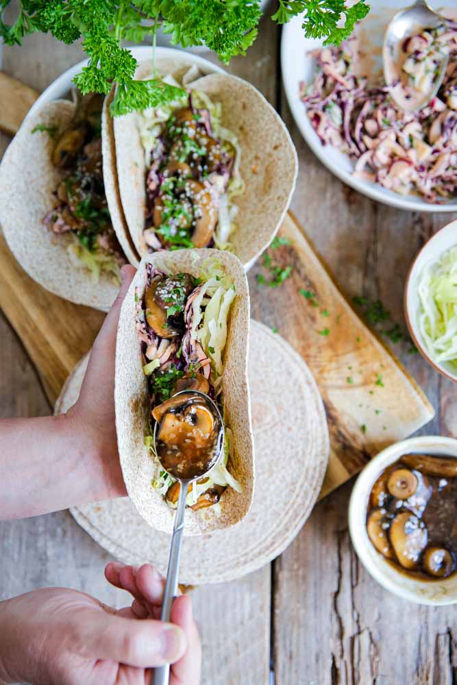 Sticky, smokey and all the Asian teriyaki flavours are piled into these mushroom tacos with a base of creamy vegan red cabbage slaw. Delicious! #veganrecipes #vegan # plantbased #easyvegan #tacotuesday #tacos #vegantacos #teriyaki #mushrooms #veganslaw #vegancoleslaw | Recipe on thecookandhim.com