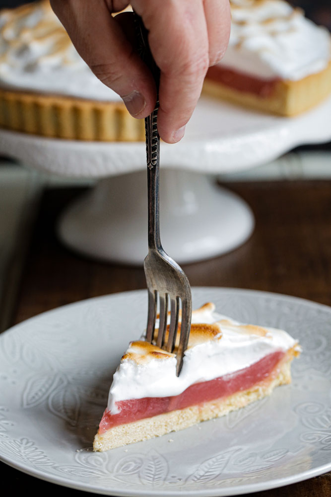 A deliciously summery vegan twist on classic lemon this raspberry meringue pie delivers slice after slice of pretty pink heaven! #veganbaking #veganmeringue #aquafaba #meringuepie #vegandessert #pie | Recipe on thecookandhim.com