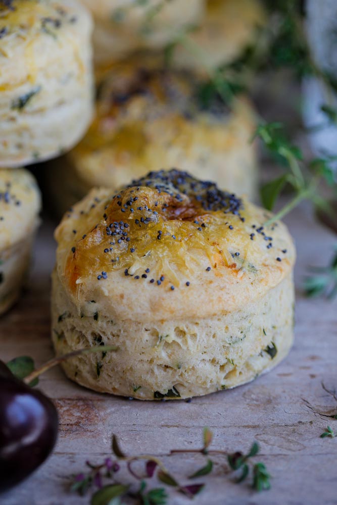 Light and fluffy vegan Smoked Applewood Cheese and Herb Scones that are just as delicious warm or cold. An easy to follow recipe, perfect for picnics, lunchboxes, savoury snack or serve alongside a hearty stew. Just split in half and serve with lashings of butter! Recipe on thecookandhim.com | #scones #vegan #veganscones #savouryscones #veganbaking #vegancheese