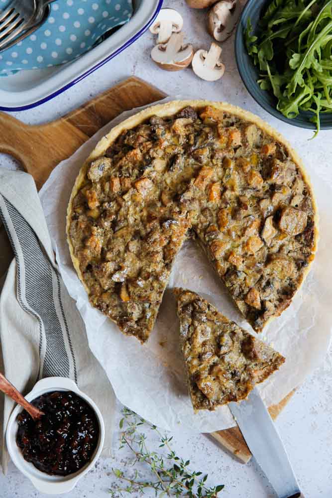 Crammed with veggies, herbs, spices and vegan sausage this mushroom tart is brimming with flavour and would make the perfect Christmas centrepiece! It will also become a firm favourite week after week for your Sunday roast! It's easy to make and can be prepared in advance and either cooked or reheated later. Recipe on thecookandhim.com | #cumberlandsausage #vegansausage #mushroompie #mushroomtart #veganpie #veganchristmas #veganrecipe #veganroast #plantbased #meatfree