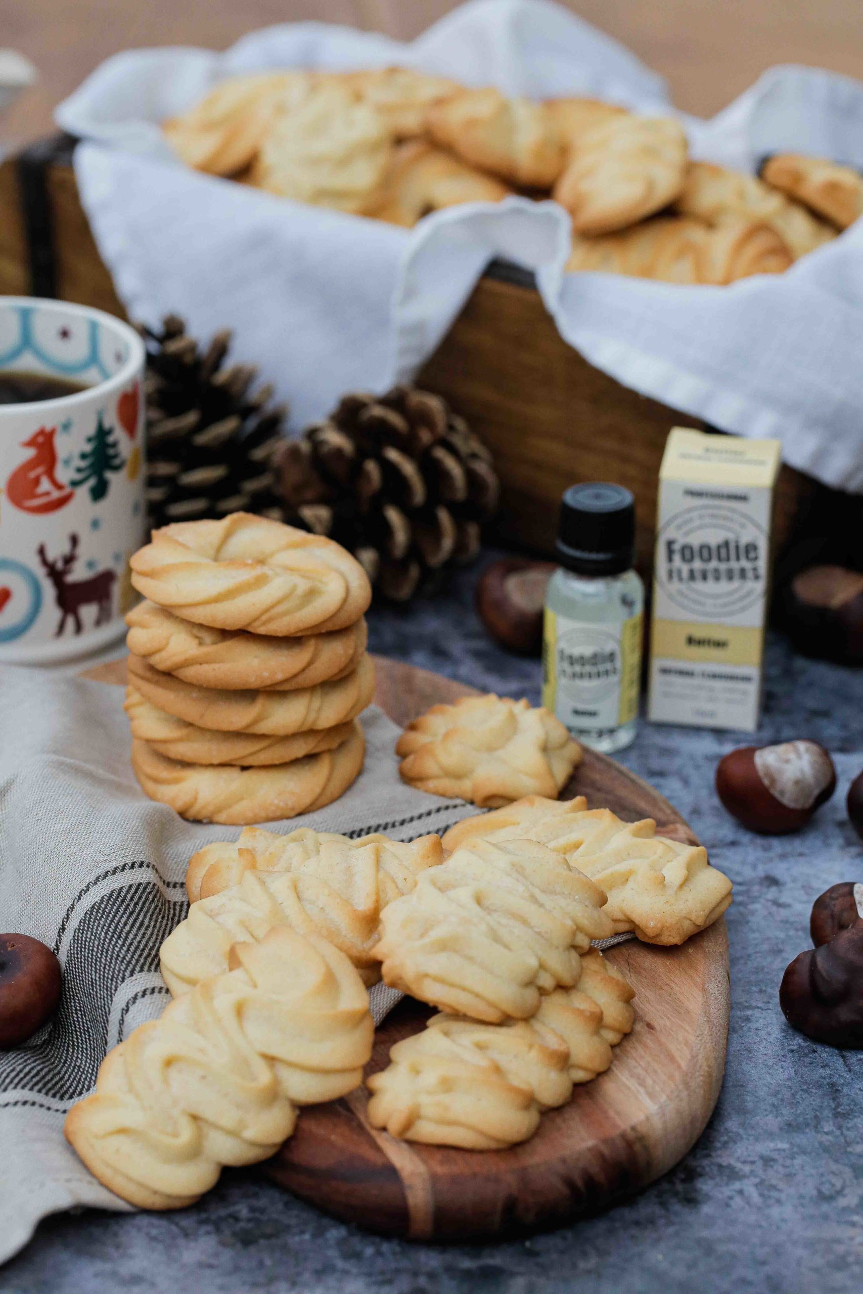 Light, crisp and delicate, my vegan version of the classic Danish Butter Cookie makes absolutely melt in the mouth delicious cookies! Just a few ingredients are needed for this simple vegan recipe that makes quite a few biscuits - perfect if you're looking for a homemade gift idea! | Recipe on thecookandhim.com #vegancookies #veganbaking #buttercookies #veganbuttercookies #danishbuttercookies #easyvegancookies #ediblegiftideas #christmascookies #veganchristmascookies