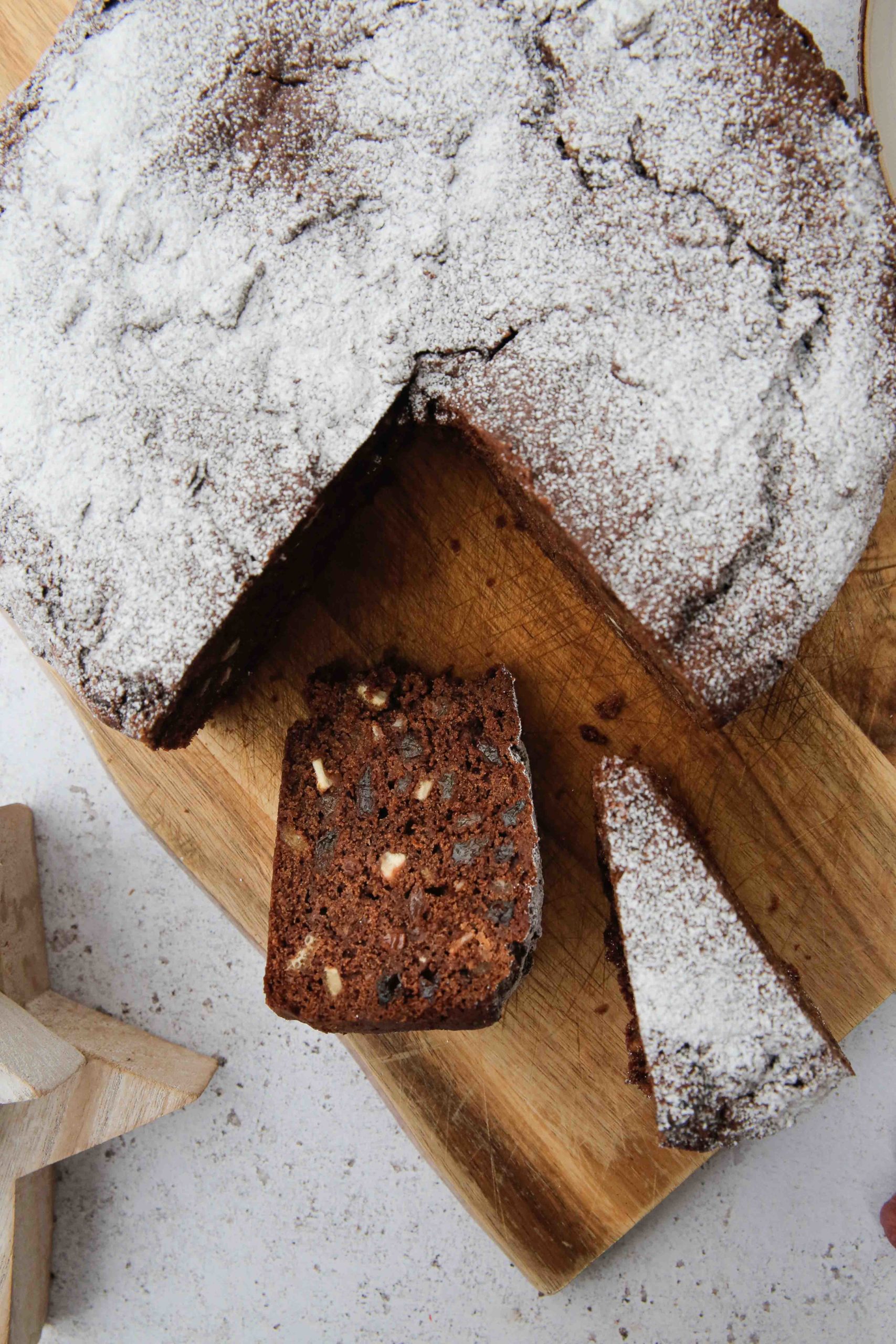 This chocolate Christmas cake is dark, squidgy, delicious and a little bit boozy! Packed with fruit and a hint of orange, the chocolate flavour is subtle but defined and adds a whole new level to a traditional Christmas cake | Recipe on thecookandhim.com #veganchristmascake #vegancake #christmascake #chocolatechristmascake #christmascake #traditionalchristmascakerecipe #veganchristmas