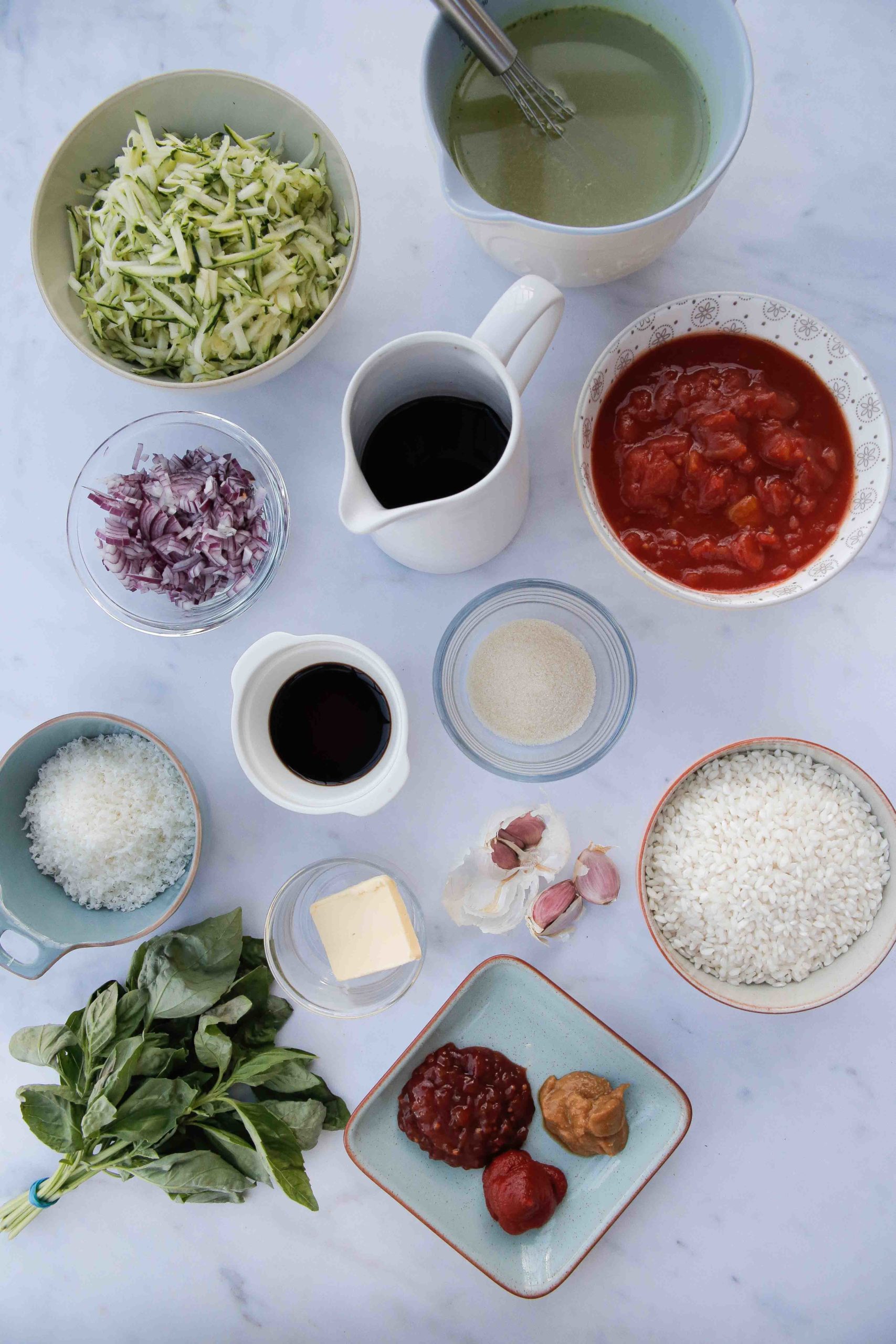 A super easy and comforting tomato risotto recipe packed with extra veggies and lots of flavour. Made with basic pantry ingredients and all cooked in one pan for an easy and delicious midweek dinner | Recipe on thecookandhim.com #risotto #veganrecipes #vegetarianrecipe #onepot #glutenfree #vegandinners