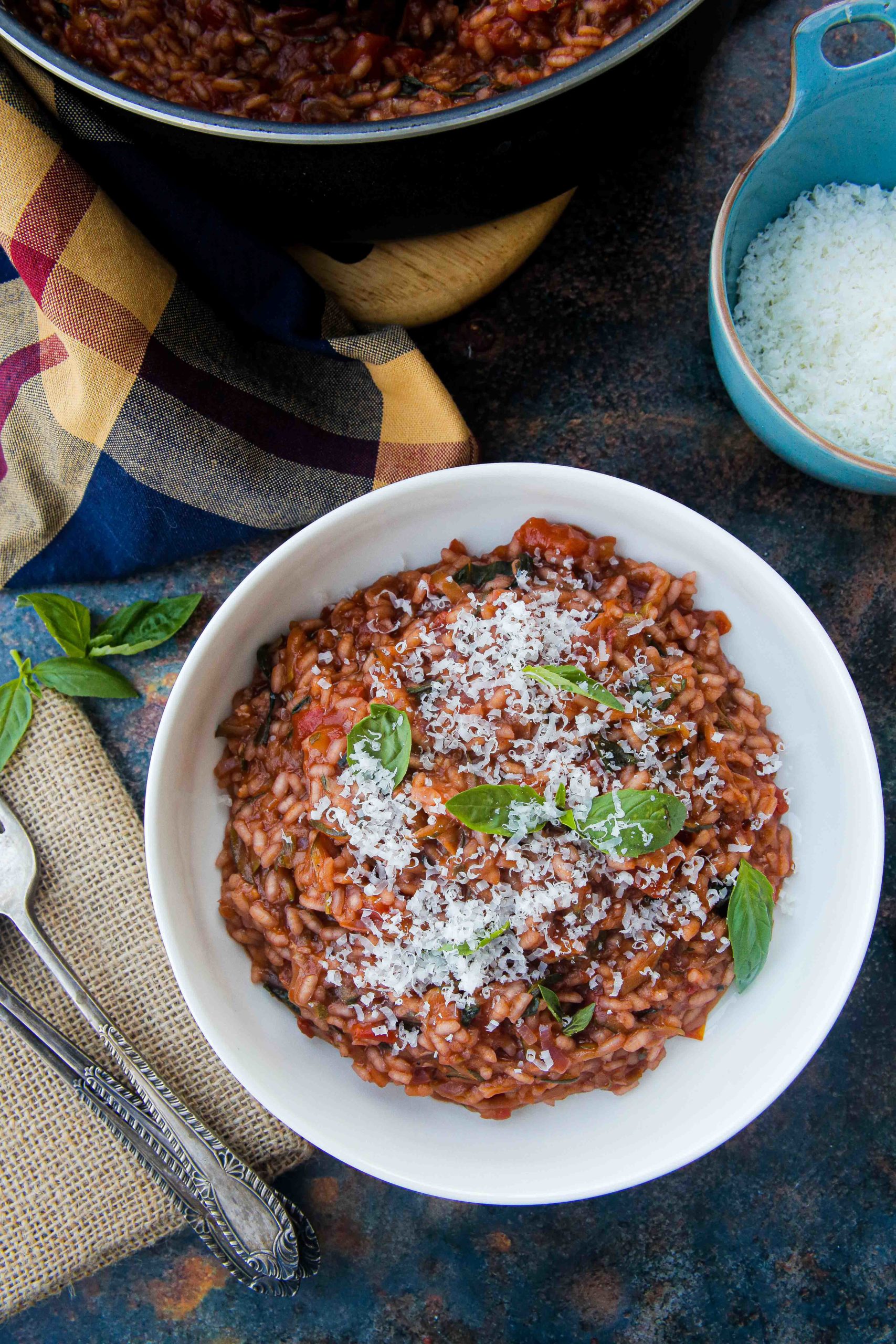 A super easy and comforting tomato risotto recipe packed with extra veggies and lots of flavour. Made with basic pantry ingredients and all cooked in one pan for an easy and delicious midweek dinner | Recipe on thecookandhim.com #risotto #veganrecipes #vegetarianrecipe #onepot #glutenfree #vegandinners