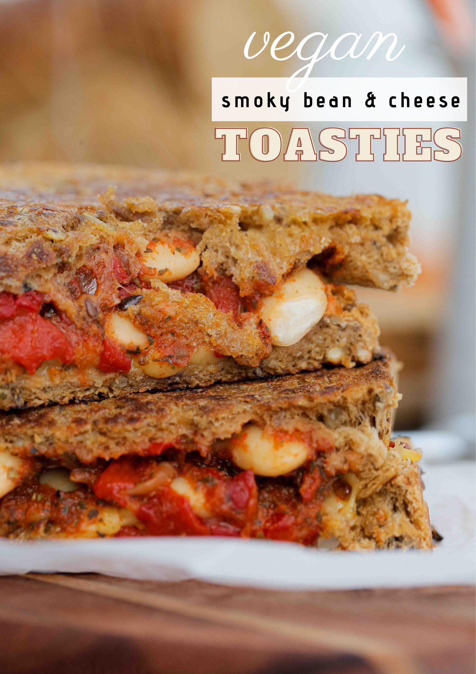 Tangy beans and vegan smoked applewood are packed in making these humble cheese toasties the ultimate comfort food! | Recipe on thecookandhim.com #cheesetoasties #vegancheese #vegansandwich #grilledcheese