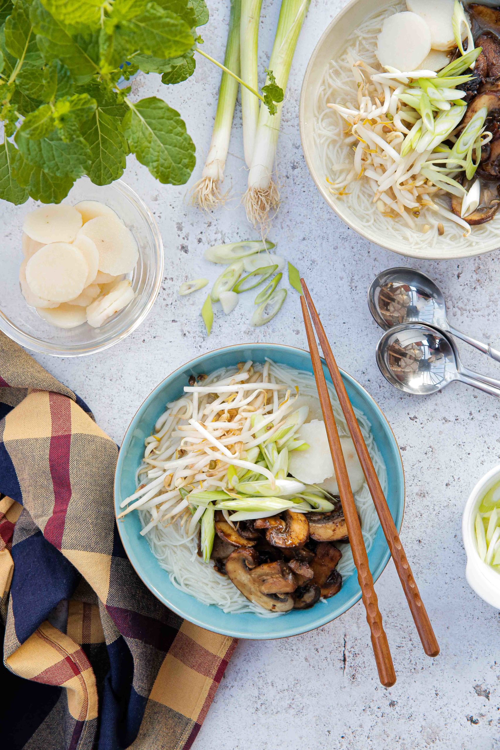 This gently spiced vegan noodle soup is full of bright fresh flavours and topped with rich umami mushrooms | Recipe on the cookandhim.com #noodlesoup #asianfood #vegan #easyveganrecipe