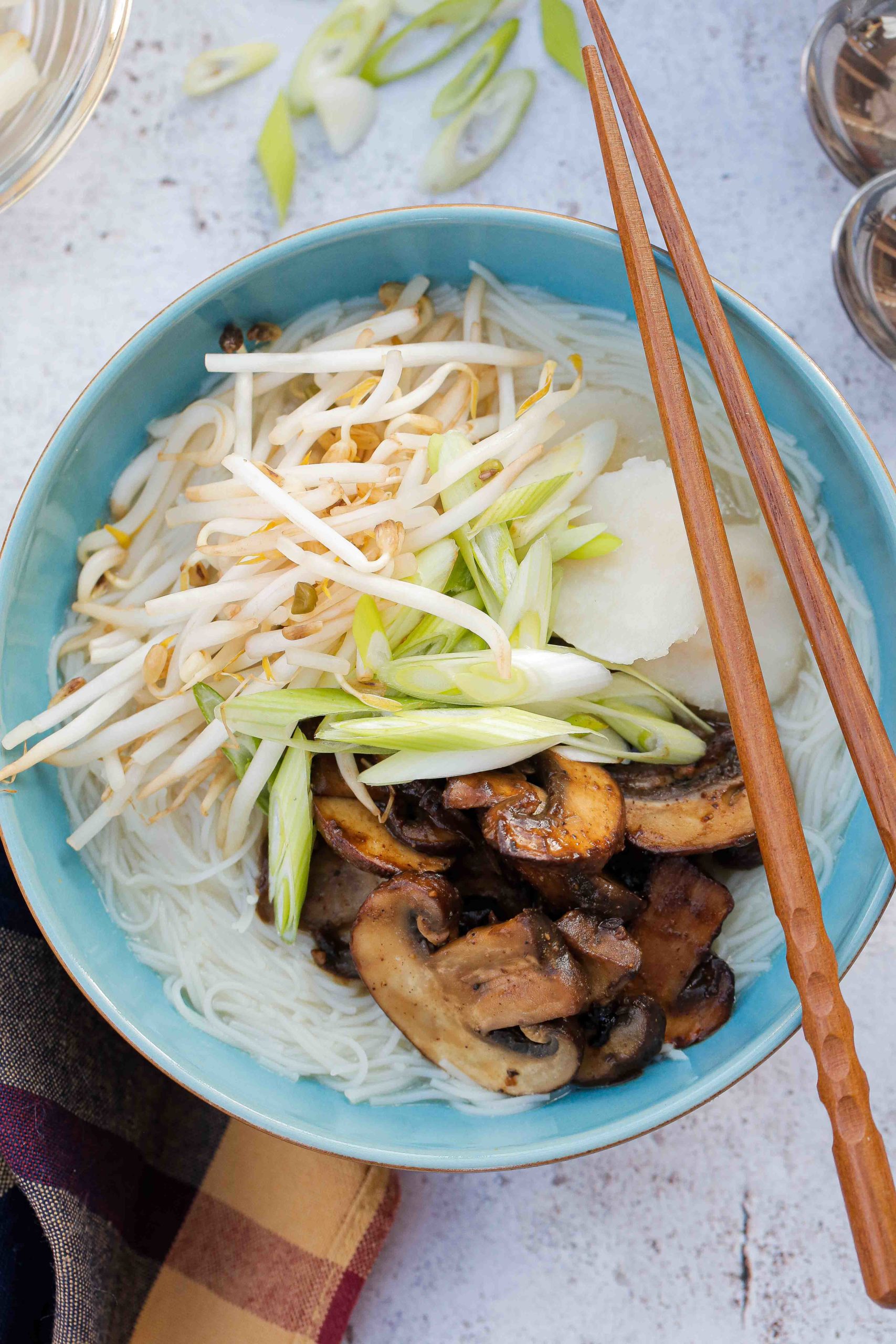 This gently spiced vegan noodle soup is full of bright fresh flavours and topped with rich umami mushrooms | Recipe on the cookandhim.com #noodlesoup #asianfood #vegan #easyveganrecipe