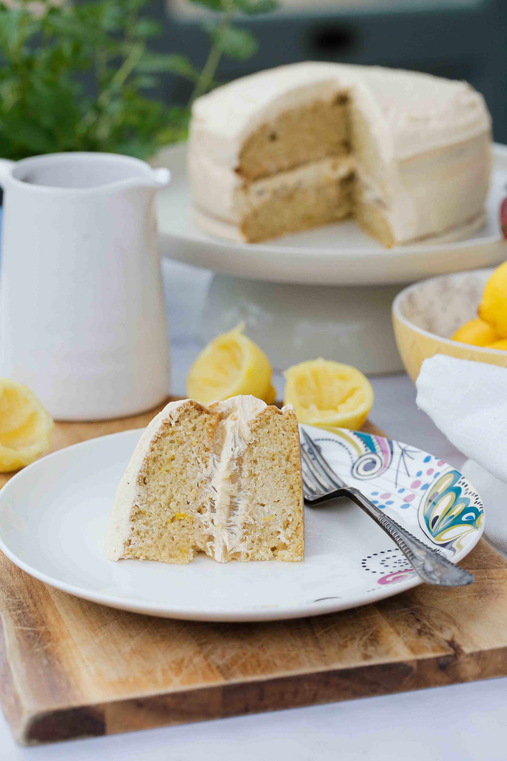 Homemade lemon curd sandwiched between lemon and vanilla sponge cakes with a lemon frosting makes this Lemon Curd Cake the perfect afternoon treat! Recipe on thecookandhim.com | #lemoncurd #lemoncurdcake #veganbaking #vegancake #dairyfree #eggfree