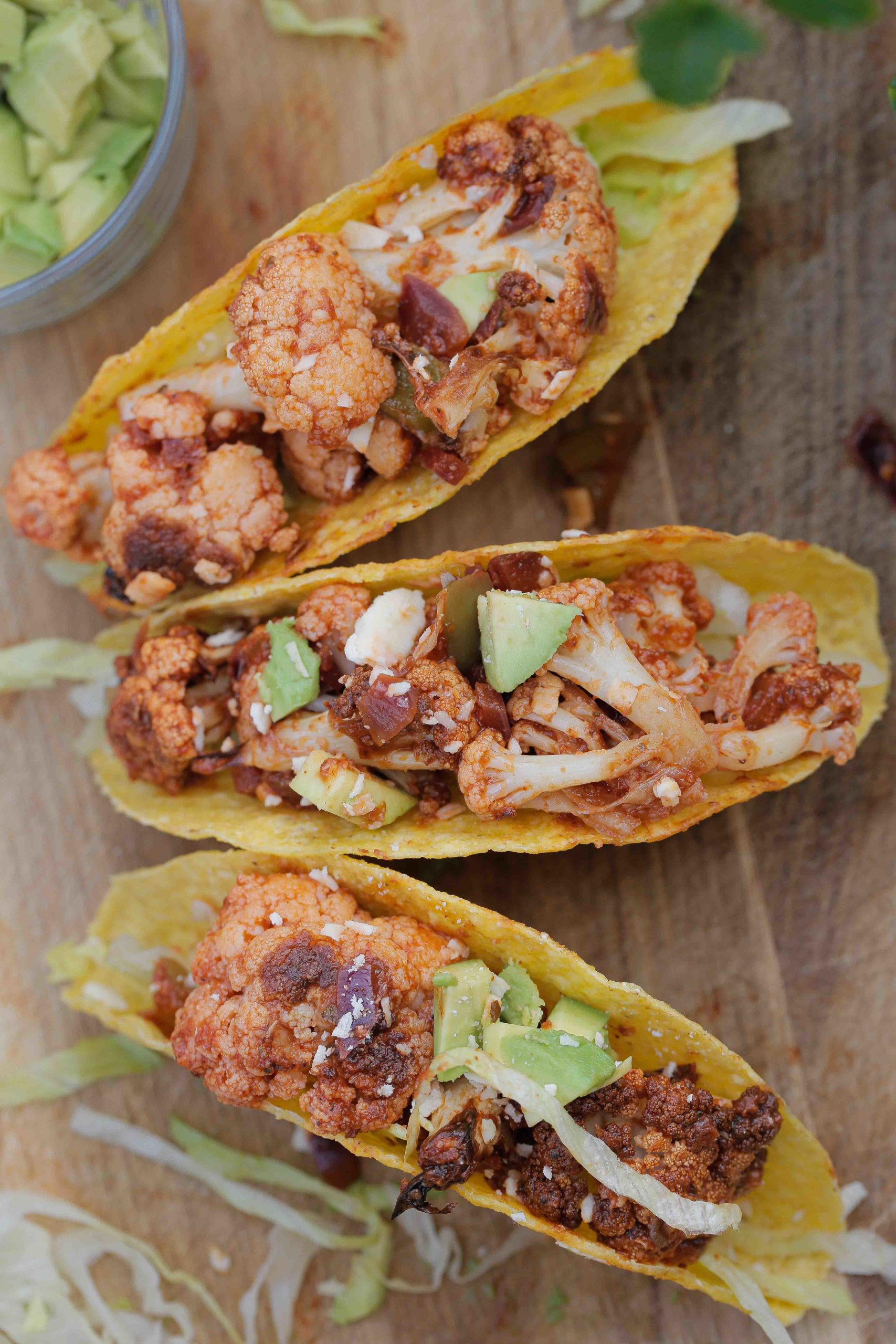 These roasted cauliflower tacos make the perfect easy midweek meal! They're crisp, a little bit spicy and so full of flavour - a real crowd and family pleaser! Recipe on thecookandhim.com #cauliflowertacos #roastedcauliflower #roastcauliflowerrecipes #cauliflowerrecipes #veggietacos