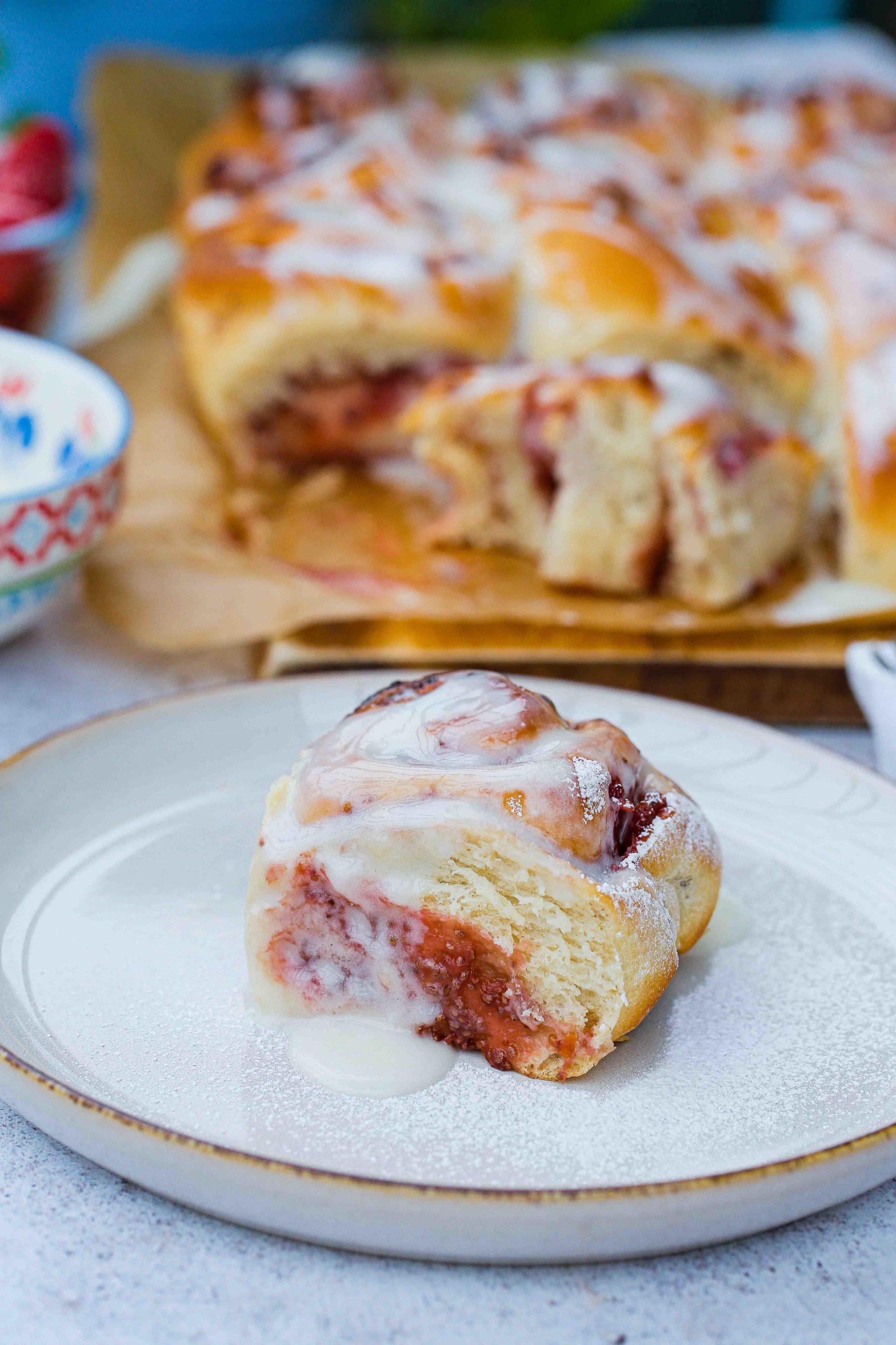 Soft, fluffy dough with a sweet homemade strawberry jam filling these vegan strawberry cinnamon rolls are such a breakfast treat! Recipe on thecookandhim.com | #strawberryrecipes #strawberrycinnamonrolls #homemadebread #cinnamonrolls #summerjam #summerfruits #strawberries