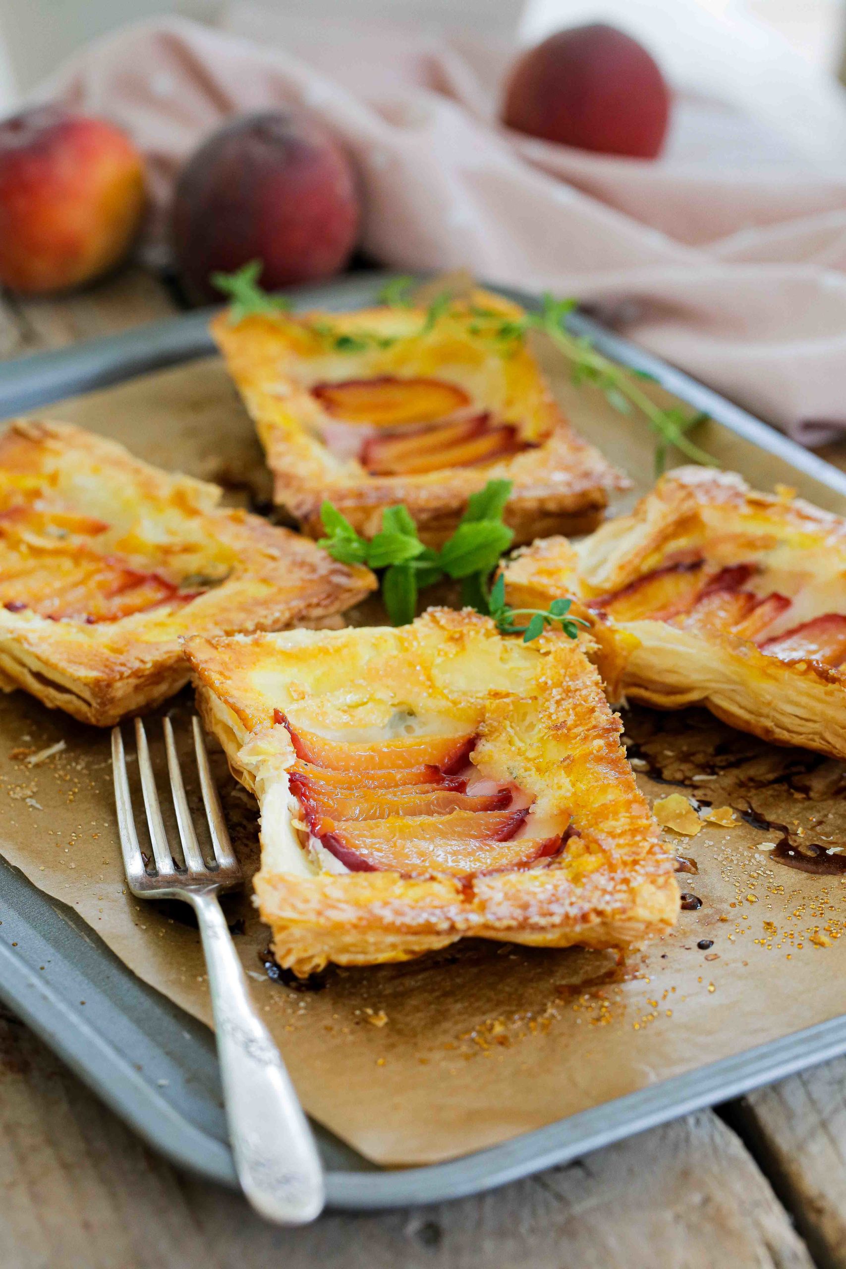 Delicious vegan desserts don't come any easier than these peach upside down tarts. The herb cream cheese adds even more garden fresh flavour! Recipe on thecookandhim.com | #vegandessertrecipes #veganpastries #upsidedowntarts #creamcheesetarts #puffpastry