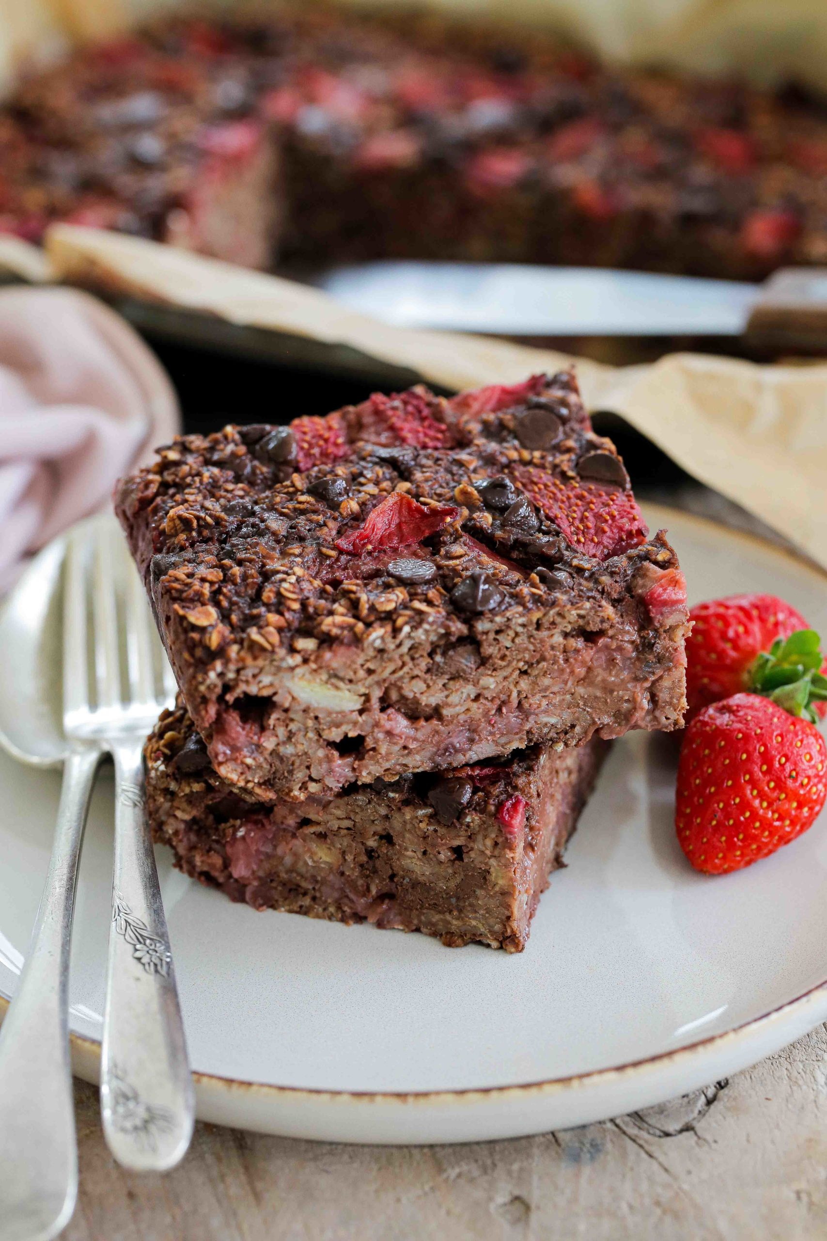 These Strawberry and Chocolate Baked Oats come together in one bowl. They're vegan, gluten free and SO easy. The perfect breakfast! Recipe on thecookandhim.com #bakedoats #bakedoatmeal #chocolatebakedoats #chocolatebakedoatmeal #healthybreakfast #veganbreakfast