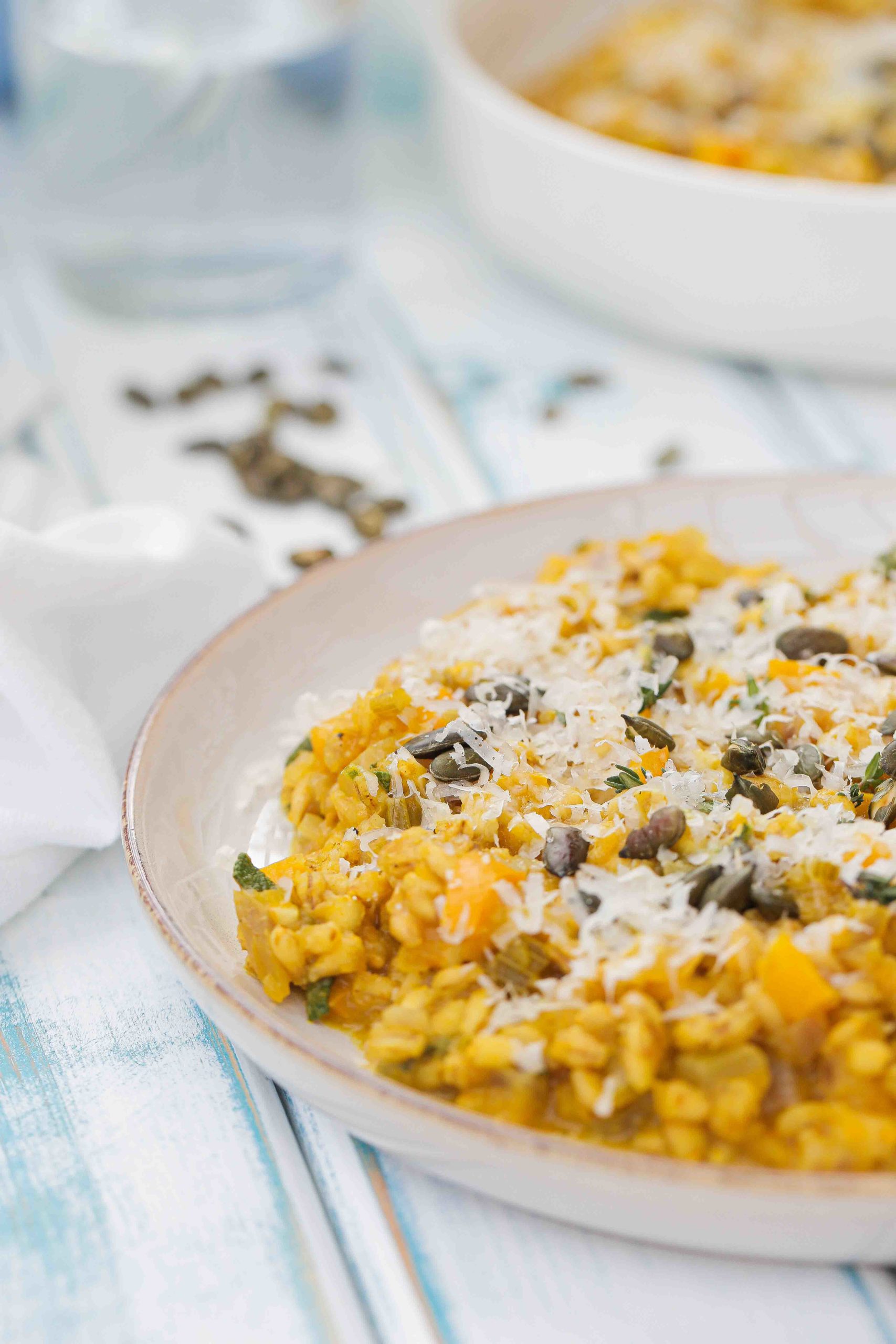 Easy, creamy, one pan pumpkin risotto with white wine, sage and pearl barley. Delicious autumn comfort food. Recipe on thecookandhim.com | #pumpkinrisotto #pearlbarley #vegan #autumnrecipes #comfortfoodrecipes #onepotrecipes #winterwarmerrecipes