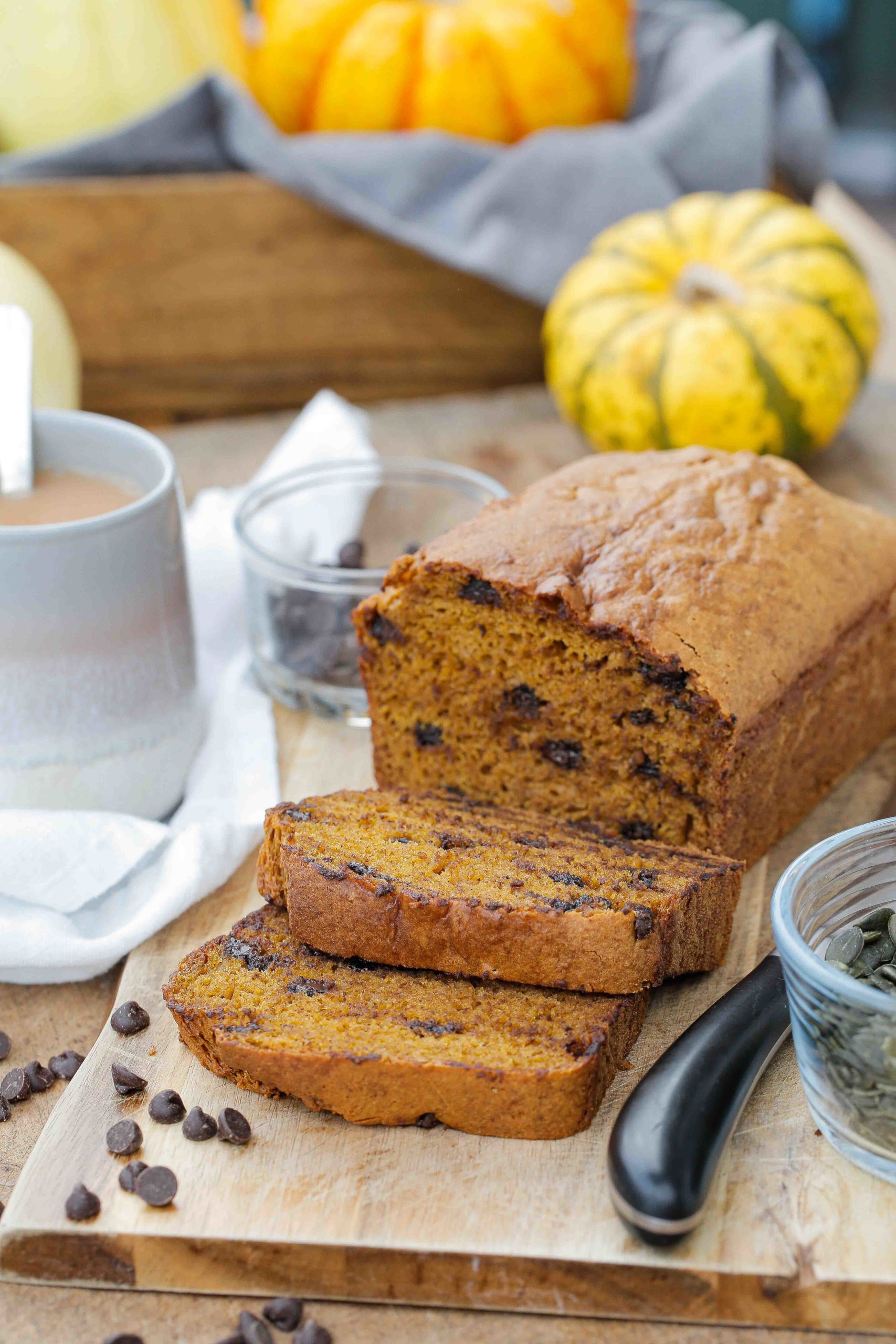 Embrace cosy autumn days with this lightly spiced, fluffy and divinely squidgy vegan pumpkin chocolate chip bread. A lovely autumn treat! Recipe on thecookandhim.com #pumpkinbread #pumpkincake #pumpkinpureerecipe #pumpkinrecipes #autumnrecipes #vegancakerecipe