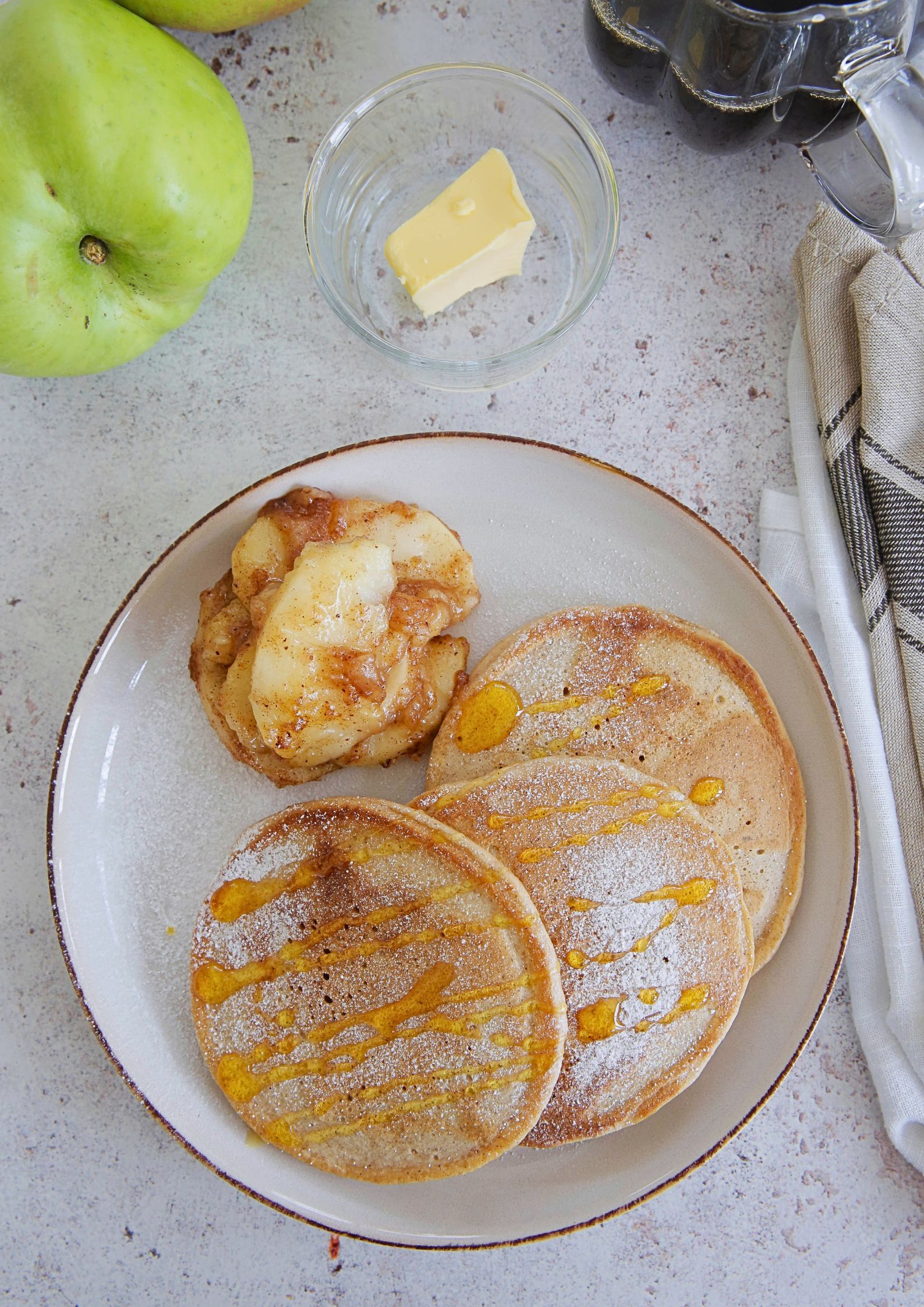 Sweet and fluffy vegan apple cider pancakes topped with a spiced apple compote. Perfect autumn weekend breakfast! Recipe on thecookandhim.com #appleciderpancakes #applepancakes #veganpancakes #eggfreepancakes #veganbreakfast #autumnrecipes