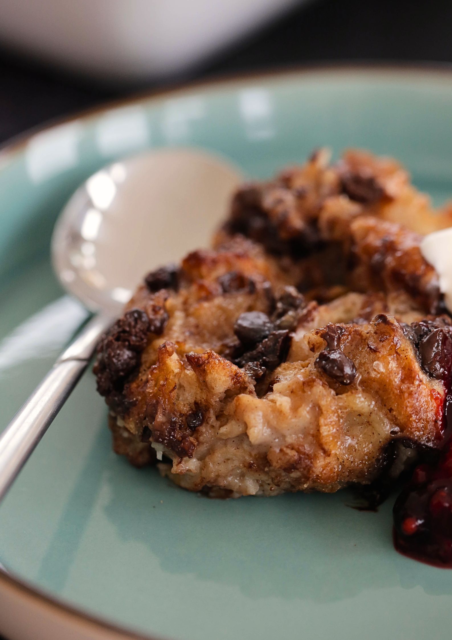 Homemade vegan croissant bread pudding is sweet, rich and custardy and studded with dark chocolate chips. Make ahead and serve with a warm berry compote and whipped cream for a special occasion dessert. Recipe on thecookandhim.com | #croissantbreadpudding #vegandessert #veganpudding #veganbaking