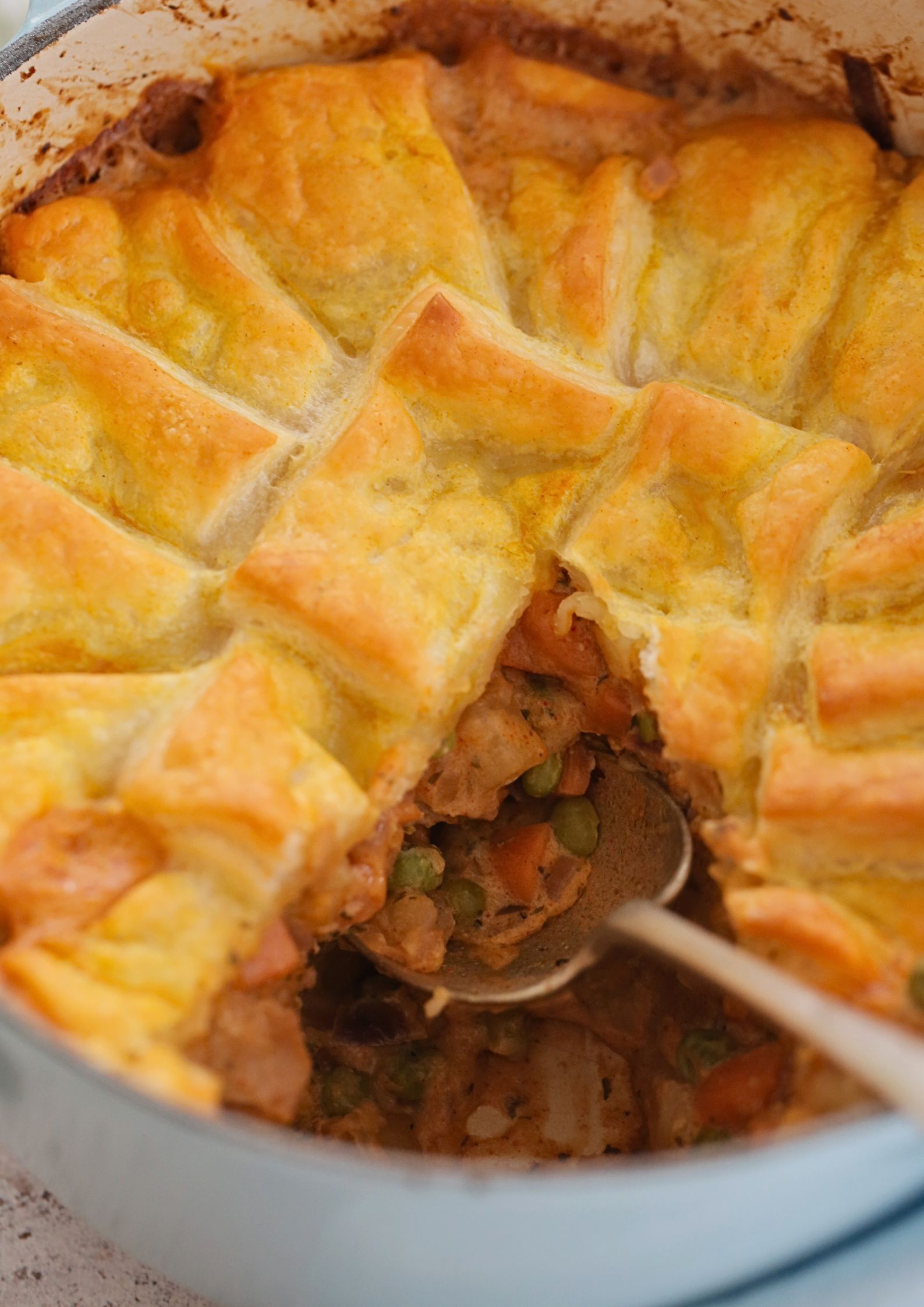 A comfort food classic made vegan! This chicken pot pie packed with veggies and topped with flaky pastry is an easy one pan meal that's absolutely full of flavour. It's also perfect for making ahead and a real family favourite! Recipe on thecookandhim.com | #veganpotpie #meatfree #veganchicken #easyveganmeal #onepanmeal #vegandinner