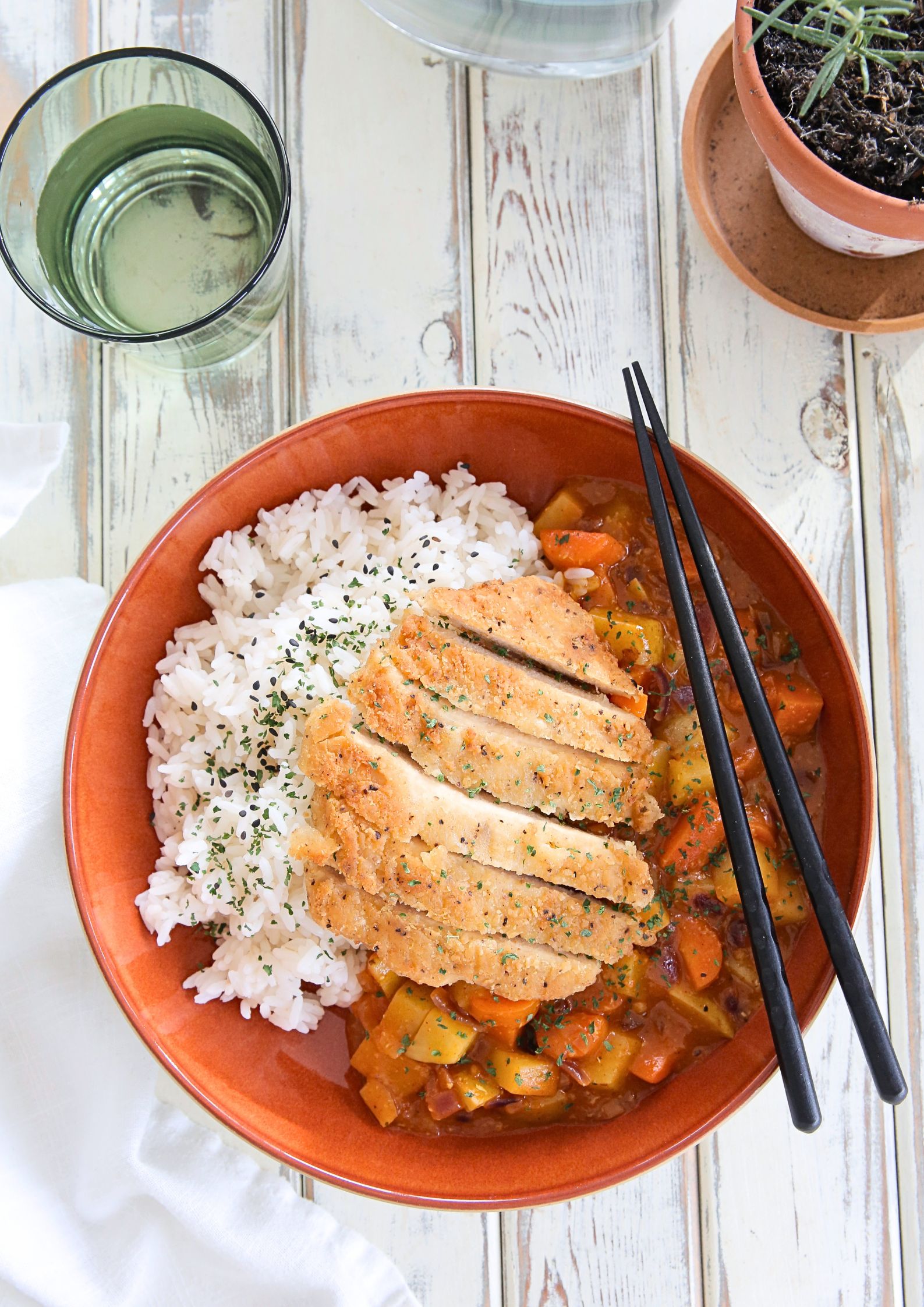 This homemade vegan chicken katsu curry is so tasty and easy to make! It's a very popular Japanese restaurant dish of crisp fried 'chicken' with a simple but punchy Japanese curry sauce. And it's all ready in around 30 minutes! Recipe on thecookandhim.com | #katsu #katsucurry #veganchicken #veganmeals #vegancurry