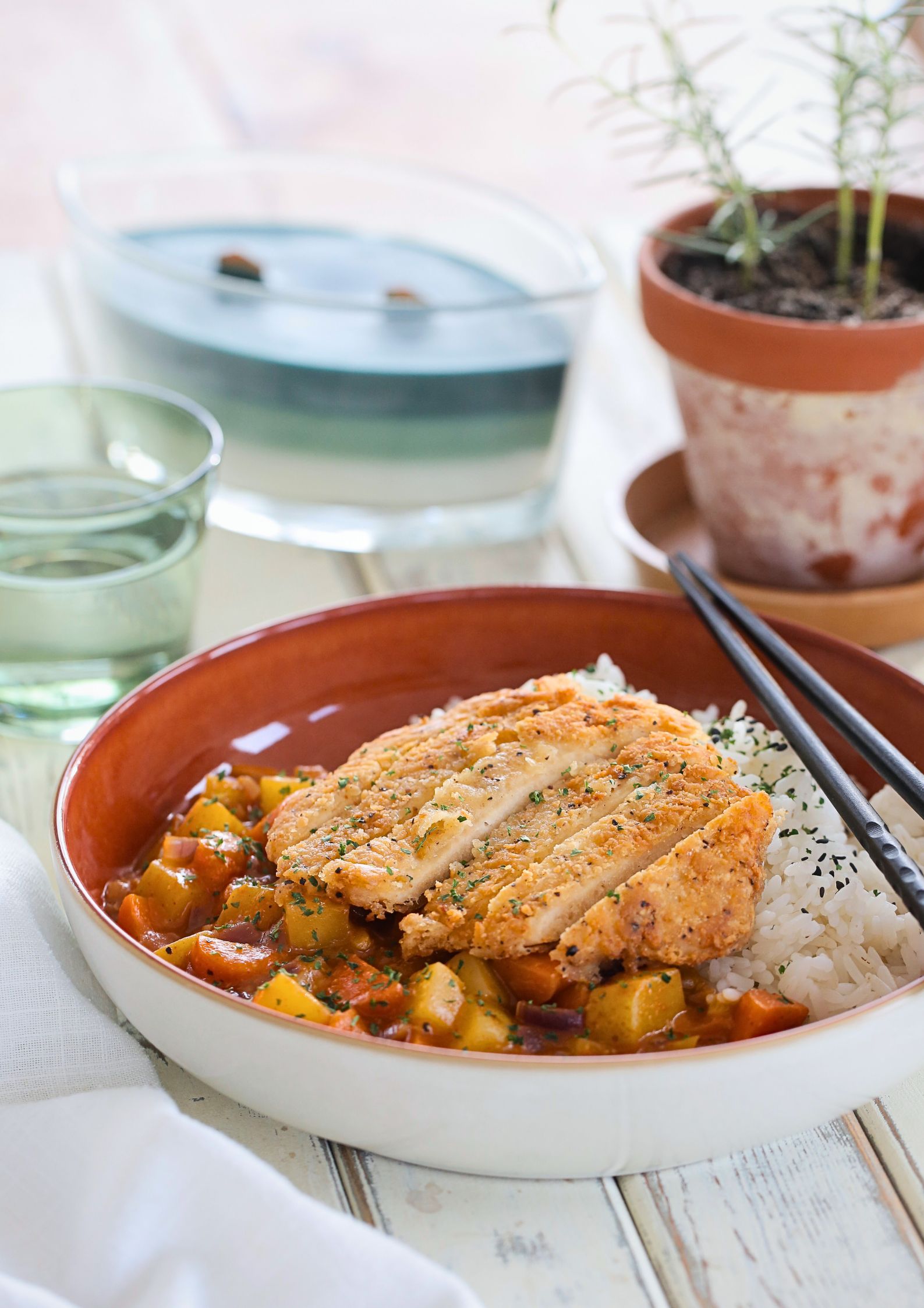 This homemade vegan chicken Katsu curry is so tasty and easy to make! It's a very popular Japanese restaurant dish of crisp fried 'chicken' with a simple but punchy Japanese curry sauce. And it's all ready in around 30 minutes! Recipe on thecookandhim.com | #katsu #katsucurry #veganchicken #veganmeals #vegancurry
