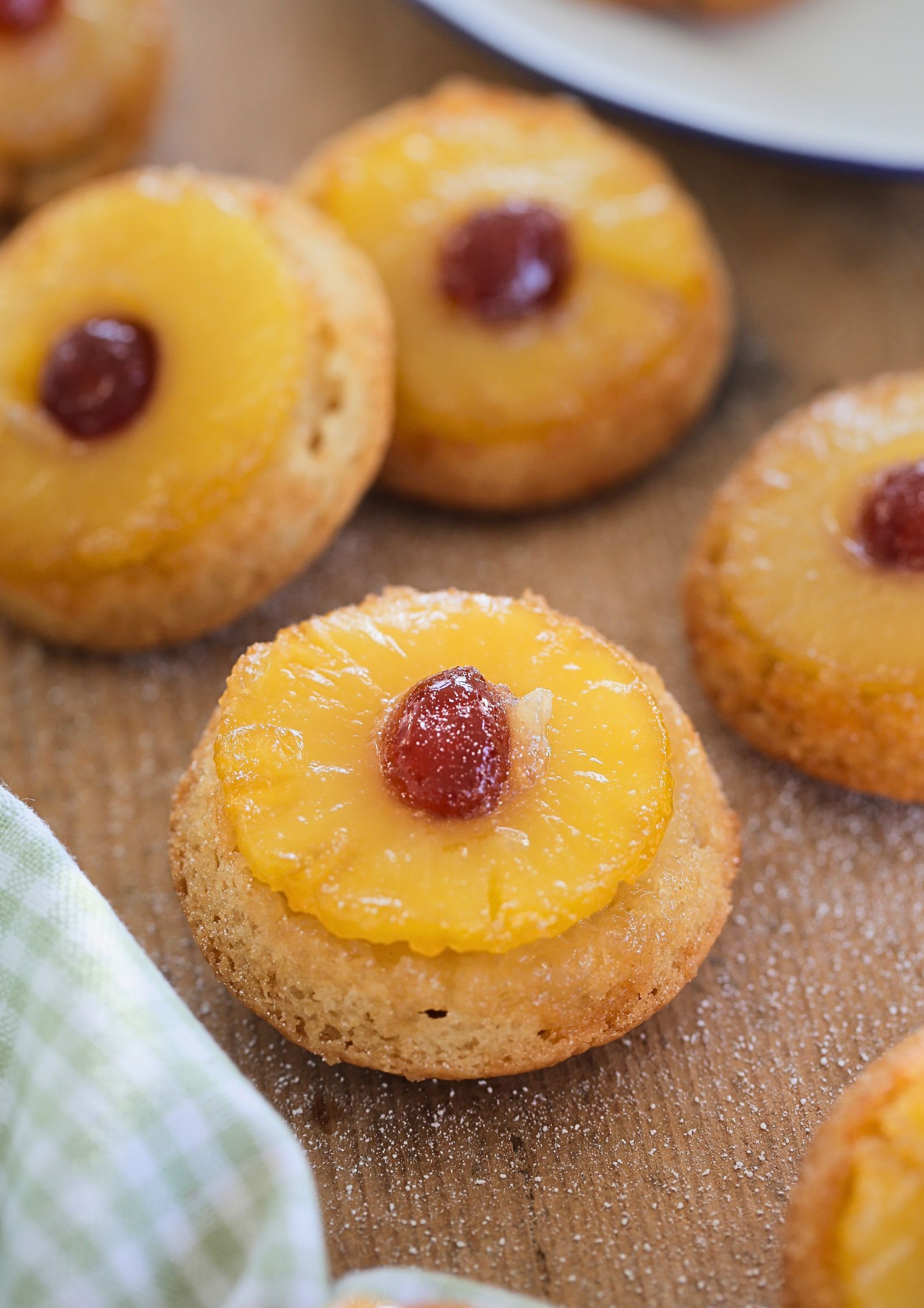 A classic for a reason, these mini vegan pineapple upside down cakes still have that sugary caramel crust, fruity pineapple, amber cherries and the easiest vegan cake mix! #pineappleupsidedowncake #pineapplecake #vegancake #eggfreecake #pineapplerecipes