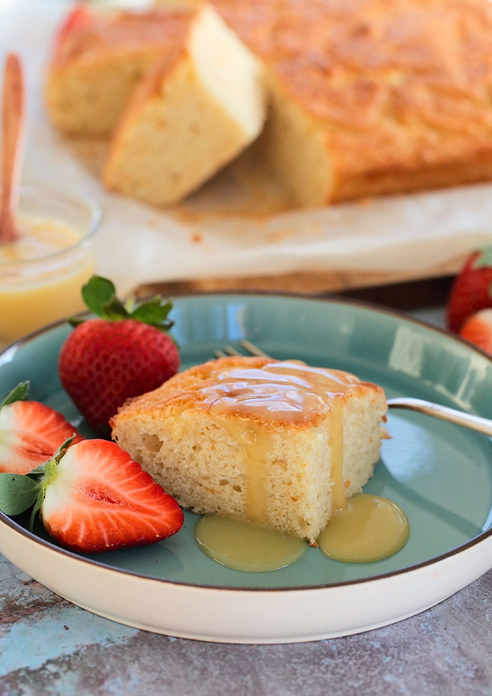 If you're a fan of oranges and lemons you're going to love this light and fluffy vegan St Clements curd cake with its sunshine flavours! A moist vegan sponge rippled with homemade curd, perfect with an afternoon cuppa or add a dollop of whipped cream for delicious dessert #vegancakerecipes #veganrecipes #vegandessert #orangecake #lemoncake