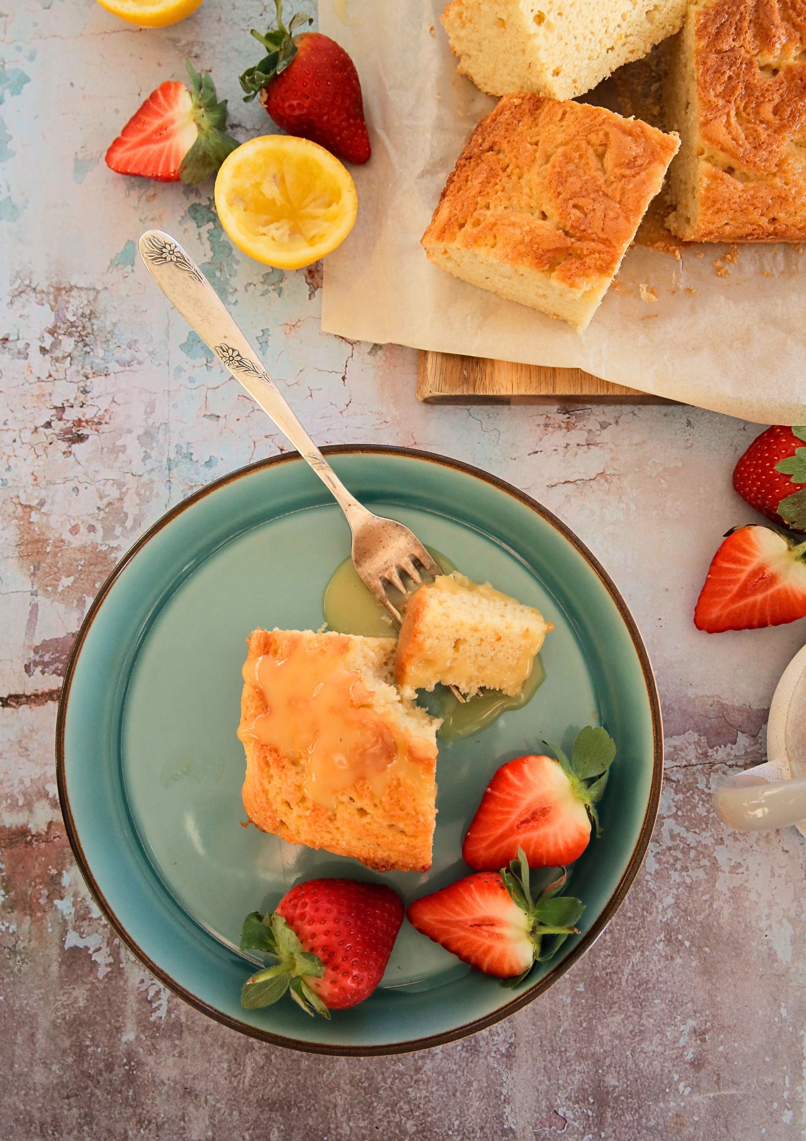 If you're a fan of oranges and lemons you're going to love this light and fluffy vegan St Clements curd cake with its sunshine flavours! A moist vegan sponge rippled with homemade curd, perfect with an afternoon cuppa or add a dollop of whipped cream for delicious dessert #vegancakerecipes #veganrecipes #vegandessert #orangecake #lemoncake