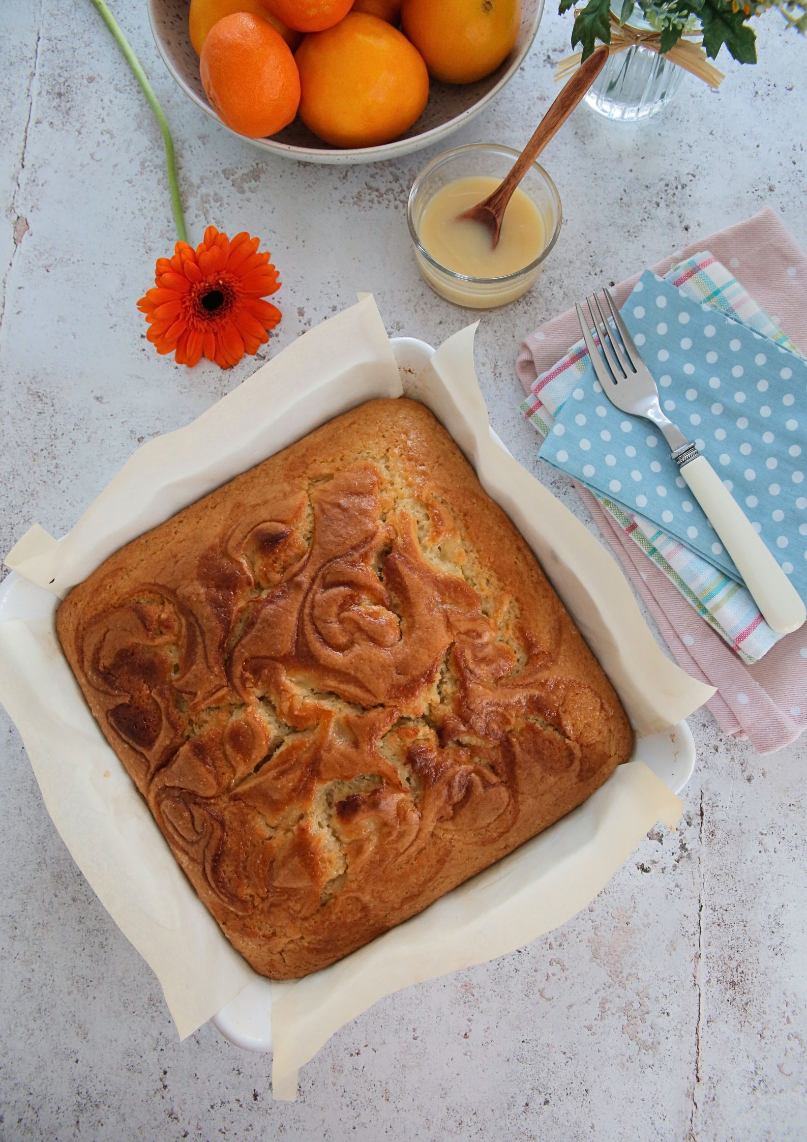 If you're a fan of oranges and lemons you're going to love this light and fluffy vegan St Clements curd cake with its sunshine flavours! A moist vegan sponge rippled with homemade curd, perfect with an afternoon cuppa or add a dollop of whipped cream for delicious dessert #vegancakerecipes #veganrecipes #vegandessert #orangecake #lemoncake