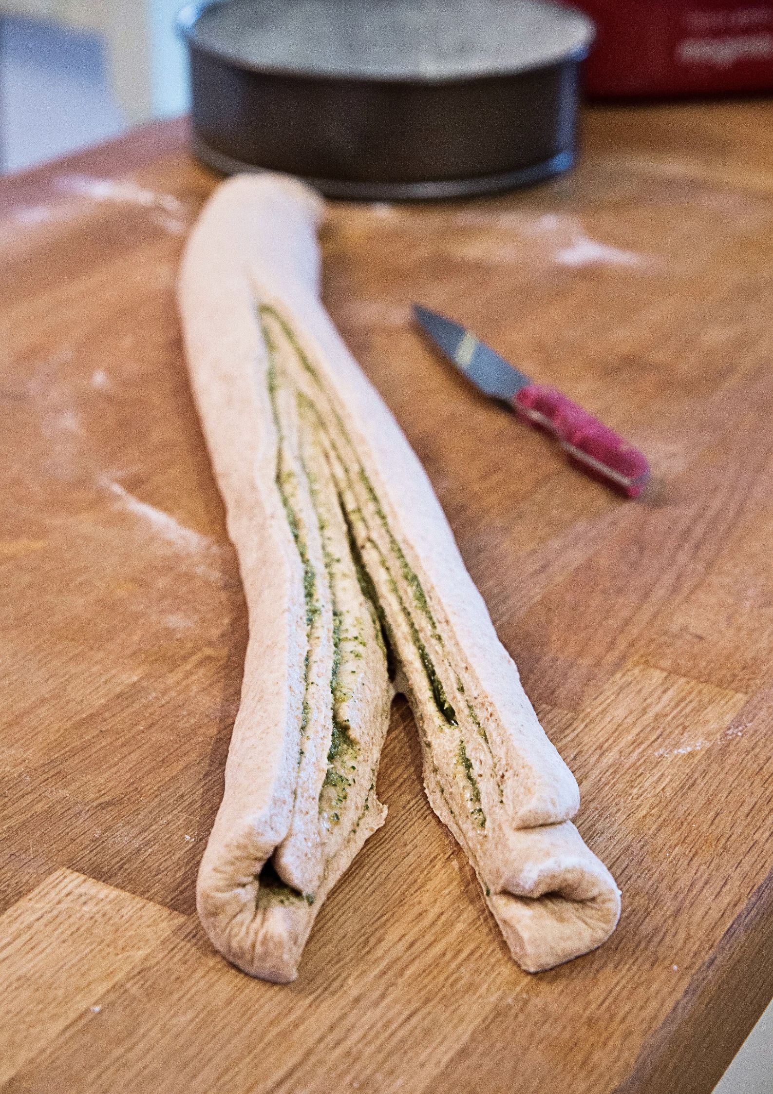 This savory braided pesto bread recipe is made from scratch. Light and fluffy, this homemade bread is braided with bright green basil pesto for a tasty, beautiful side dish.